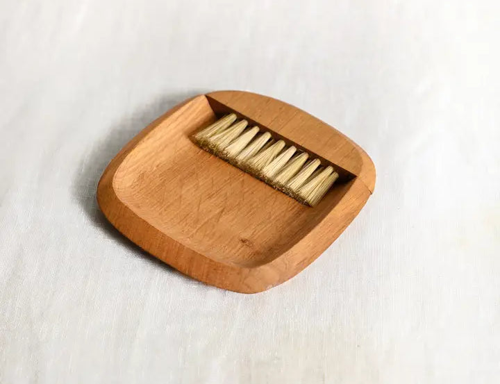 The Collective Belfort Crumb Brush Set from above with the wooden brush resting in its tray