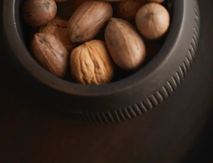 The Collective Chiseled Leila Bowl in black filled with whole walnuts, seen from above