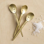 The Collective Forge Mini Spoons in Brass, three hammered gold-tone spoons with coarse salt