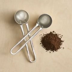 The Collective Forge Pewter Coffee Scoops Set of 2, hammered silver scoops with ground coffee
