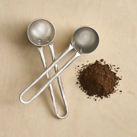 The Collective Forge Pewter Coffee Scoops Set of 2, hammered silver scoops with ground coffee