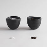 The Collective Groove Tidbit Bowls Set of 2, two small matte black textured bowls with salt and pepper