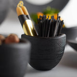 The Collective Groove Tidbit Bowl in black holding pencils, close-up of the ridged texture