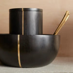 The Collective Mondrian Serving Bowl stacked with a matching black lidded canister