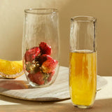 The Collective Pebbled Large Glasses holding strawberries and orange juice on a wooden board