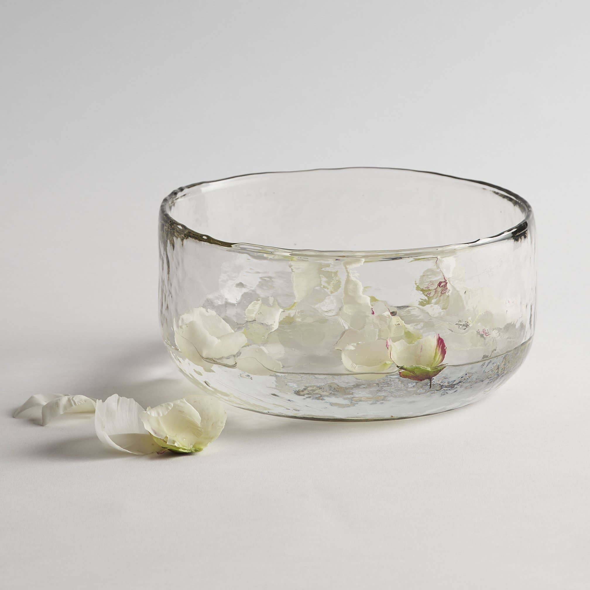 The Collective Pebbled Salad Bowl, a wide textured glass bowl with white flower petals