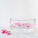 The Collective Pebbled Salad Bowl holding water and pink flower petals