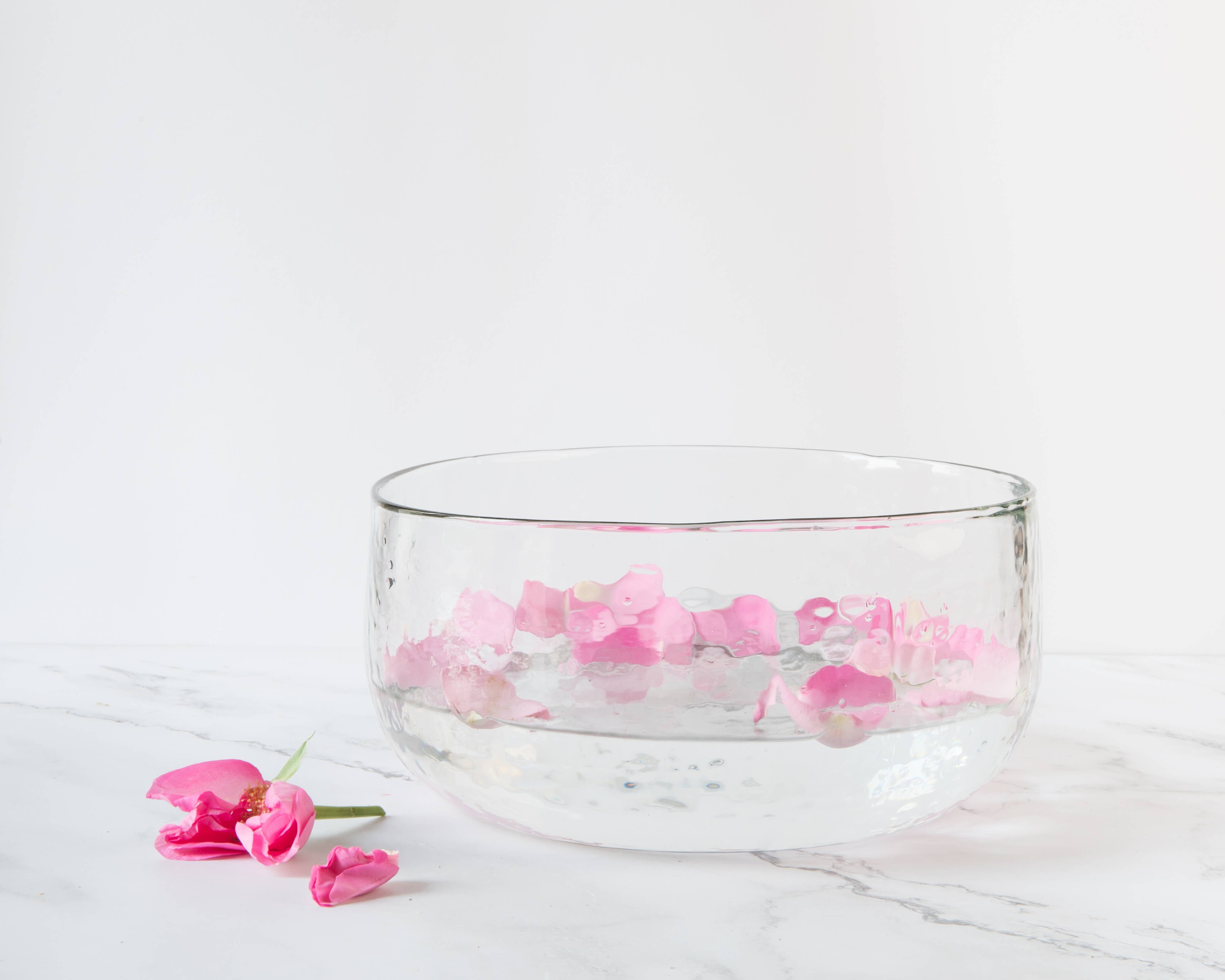 The Collective Pebbled Salad Bowl holding water and pink flower petals