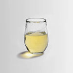 The Collective Pebbled Small Glass, a short textured glass tumbler with white wine
