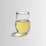 The Collective Pebbled Small Glass, a short textured glass tumbler with white wine