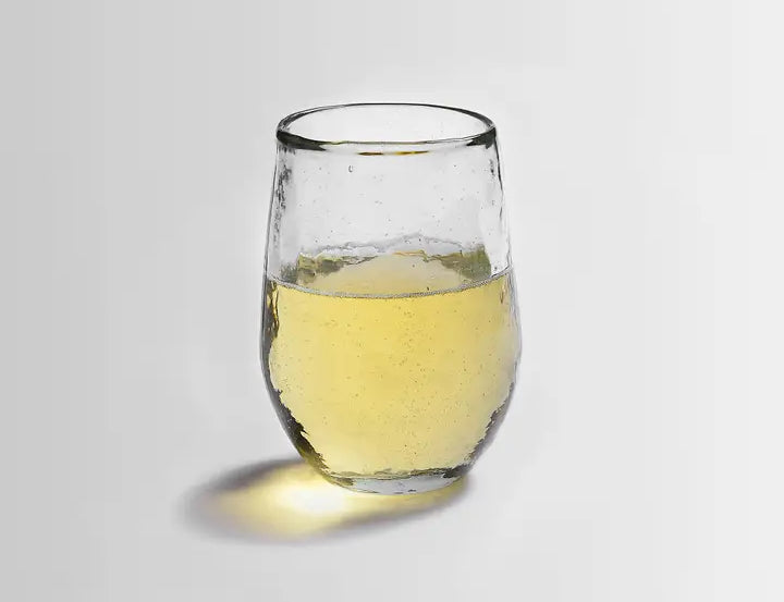 The Collective Pebbled Small Glass, a short textured glass tumbler with white wine
