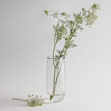 The Collective Pebbled Tall Vase, a slim textured glass vase holding wildflower stems