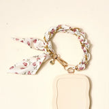 The Darling Effect Phone Scarf in Garden Party attached to a cream phone case
