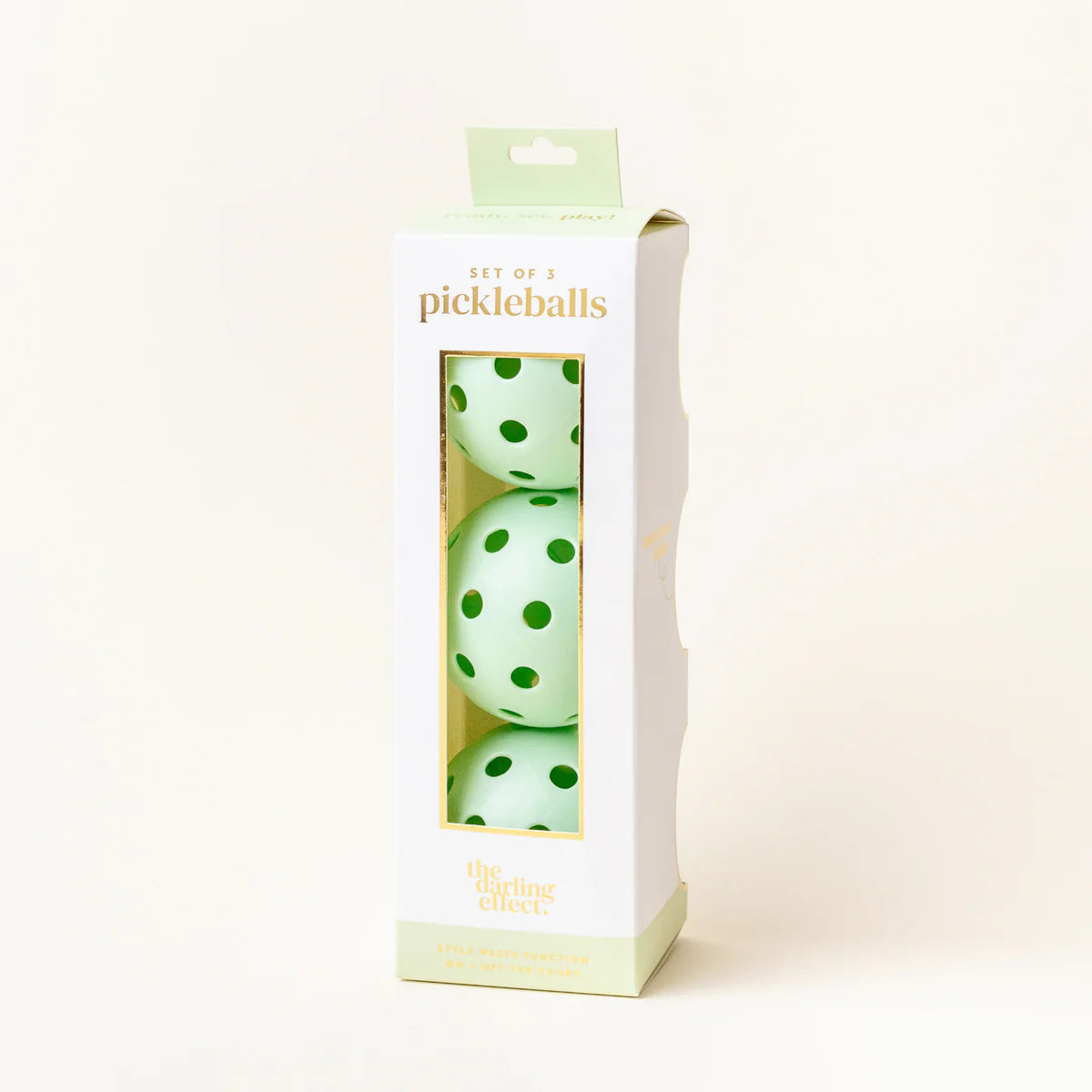 The Darling Effect Pickleball Ball Set in Green, a box of three mint green pickleballs