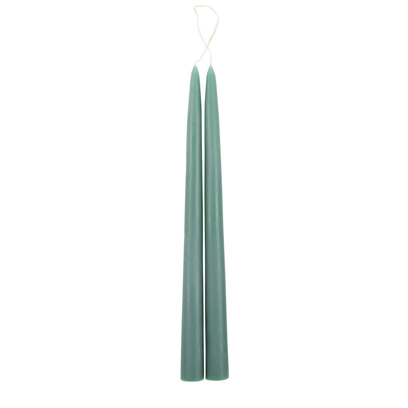 The Floral Society 18-inch Dipped Taper Candles in Moss green, a pair of sage-green tapers hanging by their wick on white