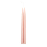 The Floral Society 18-inch Dipped Taper Candles in Petal, a pair of soft blush pink tapers hanging by their wick on white