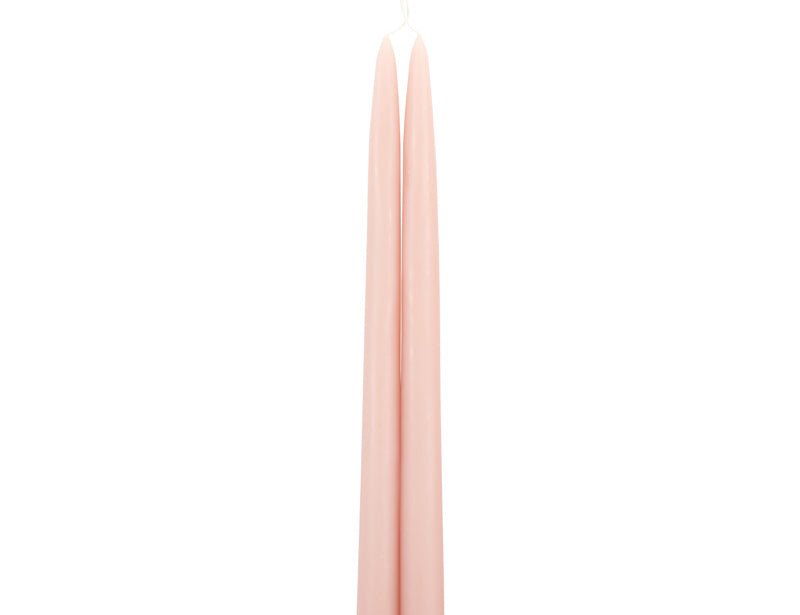 The Floral Society 18-inch Dipped Taper Candles in Petal, a pair of soft blush pink tapers hanging by their wick on white