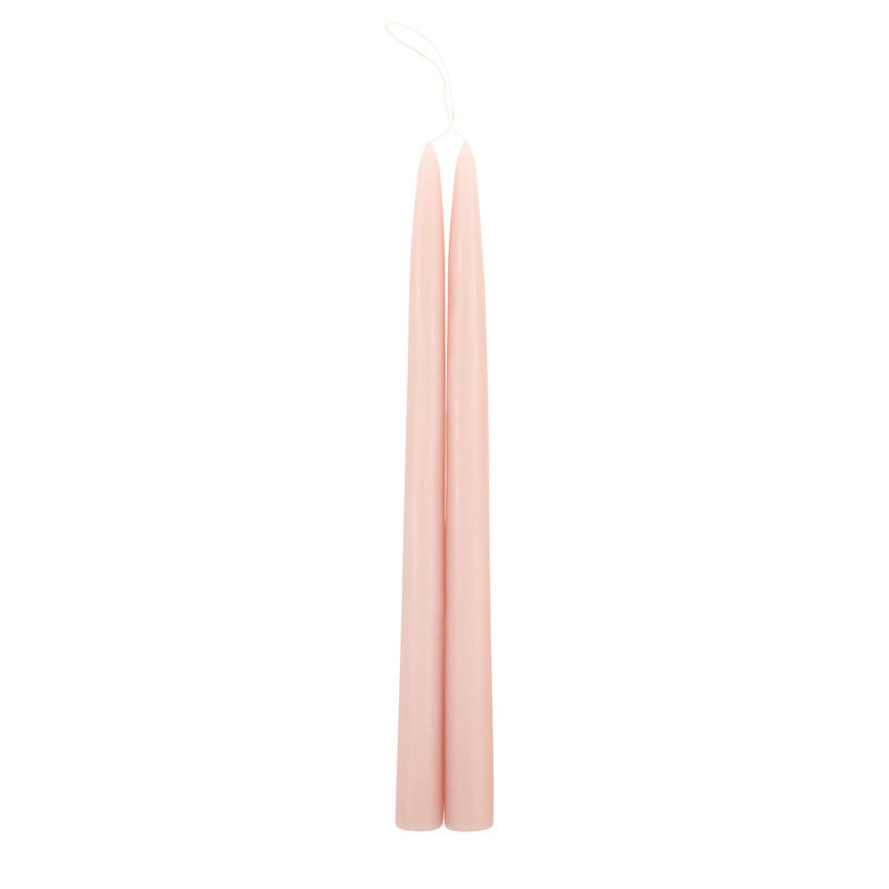 The Floral Society 18-inch Dipped Taper Candles in Petal, a pair of soft blush pink tapers hanging by their wick on white