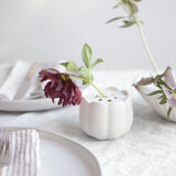 The Floral Society Ceramic Flower Frog Vases with single dark and pale flower stems on a table