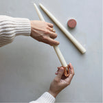 Hands sharpening a cream taper candle with The Floral Society Copper Candle Sharpener