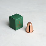 The Floral Society Copper Candle Sharpener beside its small green gift box