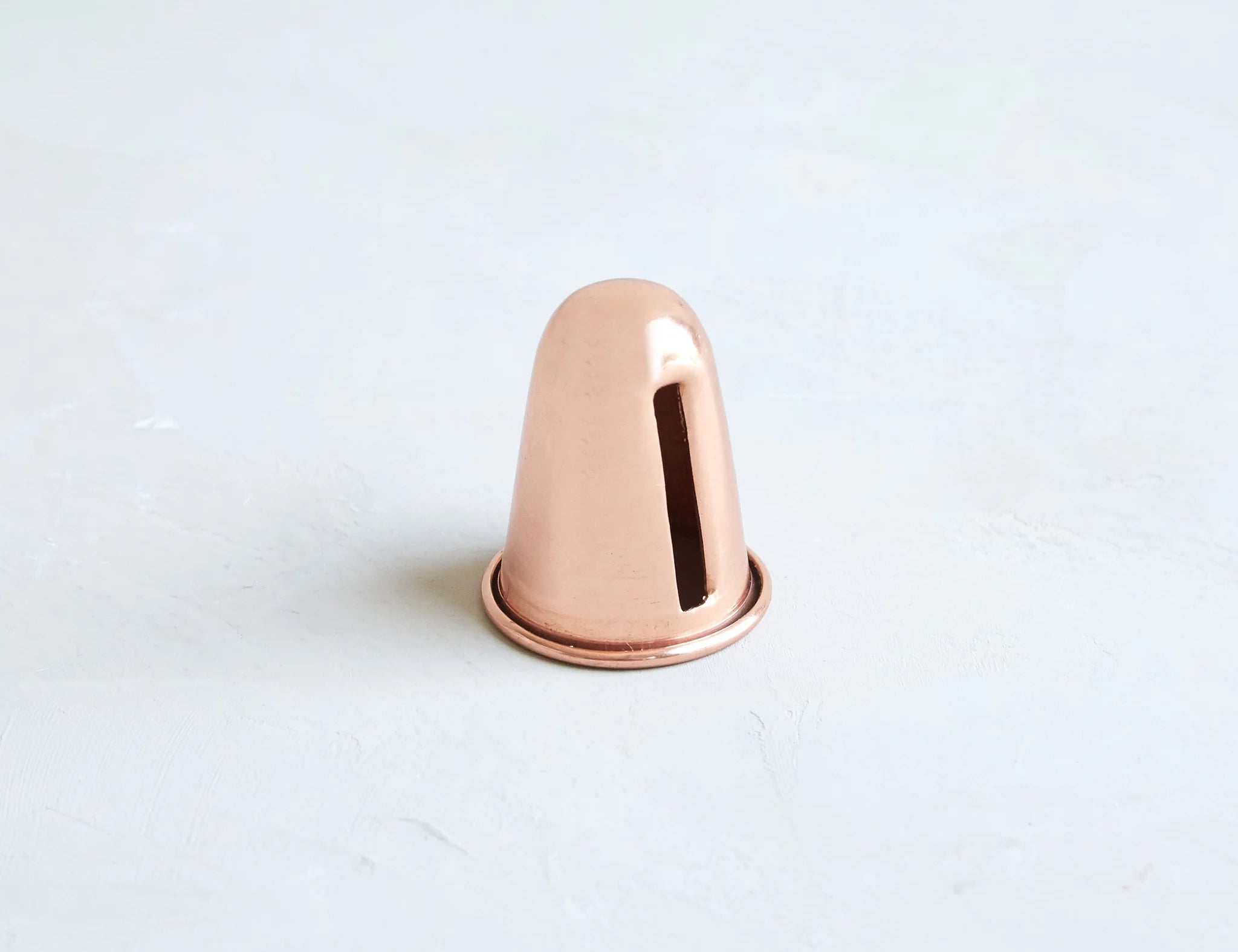 The Floral Society Copper Candle Sharpener, a small copper cone-shaped tool