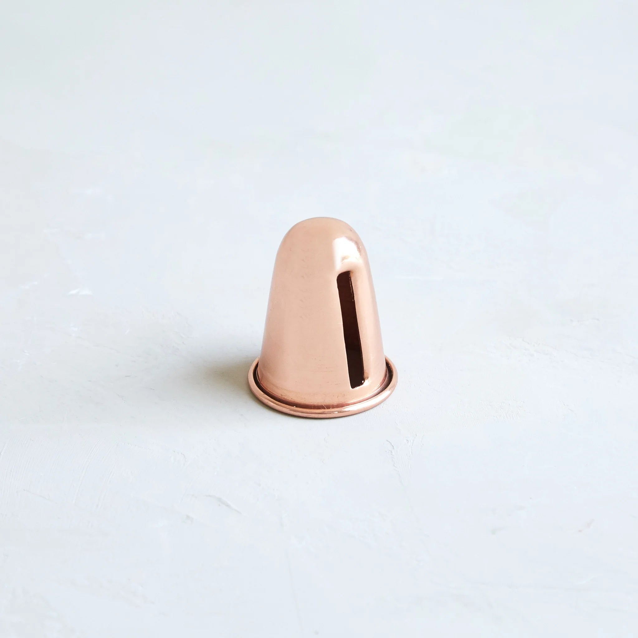 The Floral Society Copper Candle Sharpener, a small copper cone-shaped tool