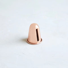 The Floral Society Copper Candle Sharpener, a small copper cone-shaped tool