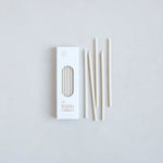 The Floral Society Wishing Candles in Parchment, thin cream taper candles beside their white box
