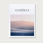 The Gospels book, a white cover with a soft pink and blue landscape photo