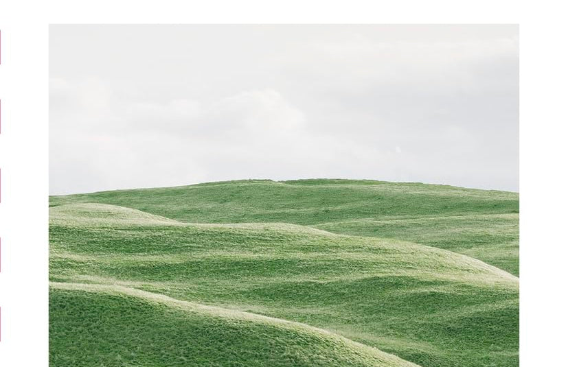 The Mini Psalms book, a white cover with a photo of rolling green hills