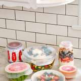 W&P Reusable Stretch Lids covering bowls of fruit and salad on a kitchen counter