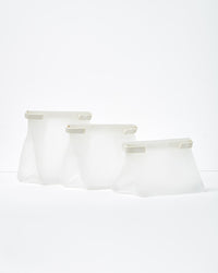 W&P Roll Tight Freezer Storage Bag Set, three clear silicone bags in graduated sizes standing open