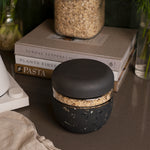 W&P Seal Tight Bowl in Terrazzo Charcoal filled with granola on a kitchen counter beside cookbooks