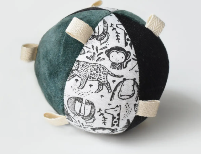 Wee Gallery Taggy Ball with Rattle, a black and white animal-print fabric ball with green velvet and tag loops