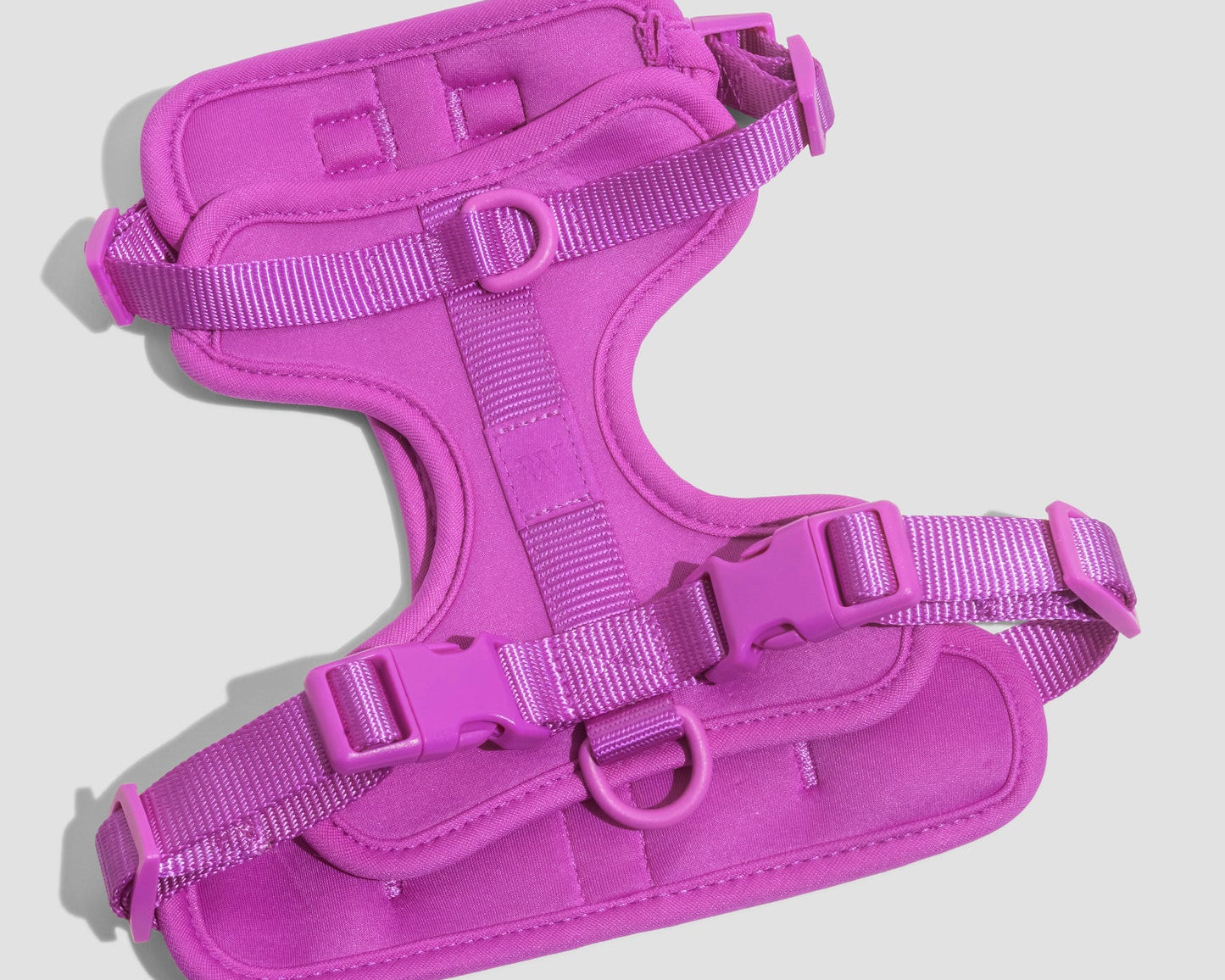 Wild One Dog Harness in Orchid, a magenta padded adjustable harness, laid flat