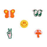 Wild One Groovy Small Flair Charms: an orange butterfly, green eyes, yellow smiley, peace sign and pink mushroom