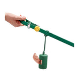 Hand holding a green Wild One leash decorated with Groovy Flair Charms and a poop bag carrier