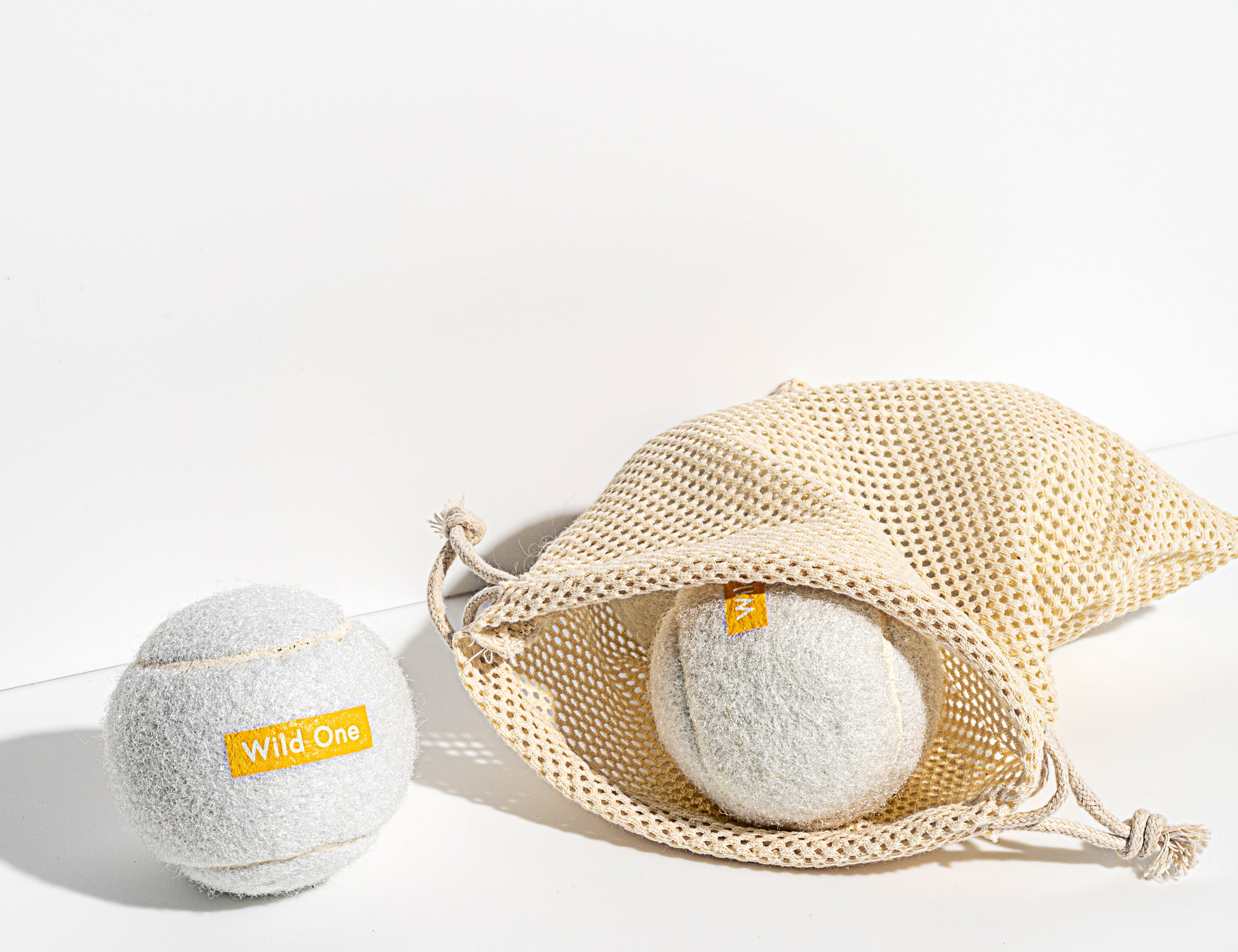 Wild One Tennis Balls in White with a mesh carry bag
