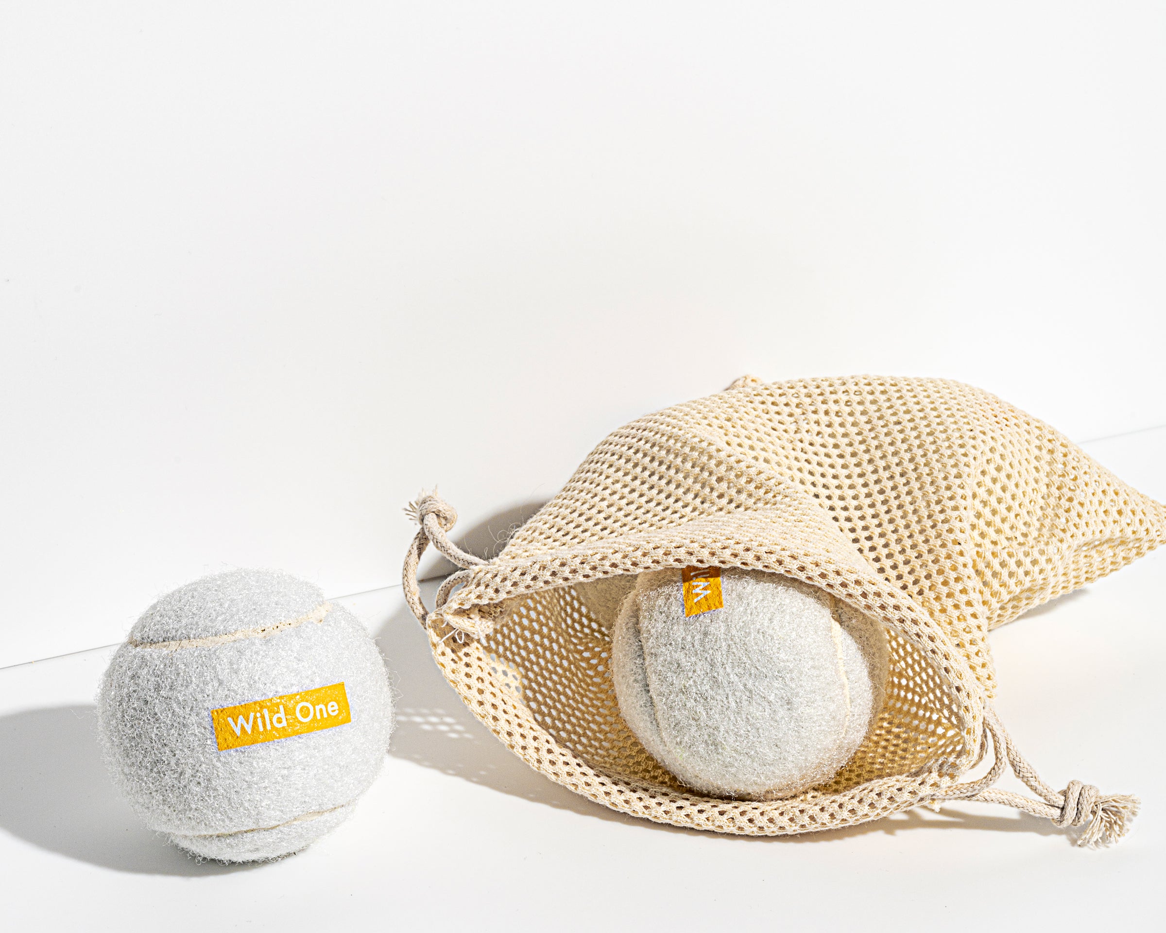 Wild One Tennis Balls in White with a mesh carry bag