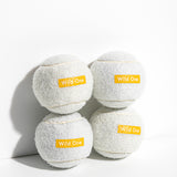 Wild One Tennis Balls in White, four white felt balls stacked with an orange Wild One logo