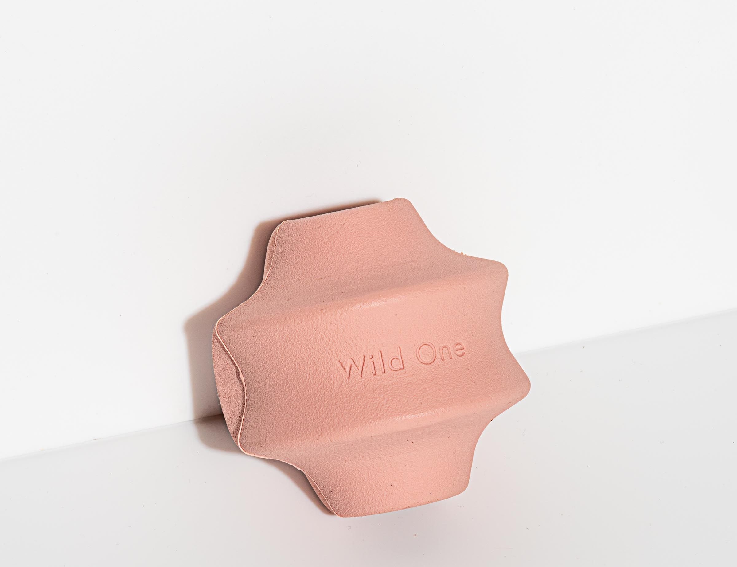 Wild One Twist Toss Dog Toy in Blush, a pink rubber twisted treat toy