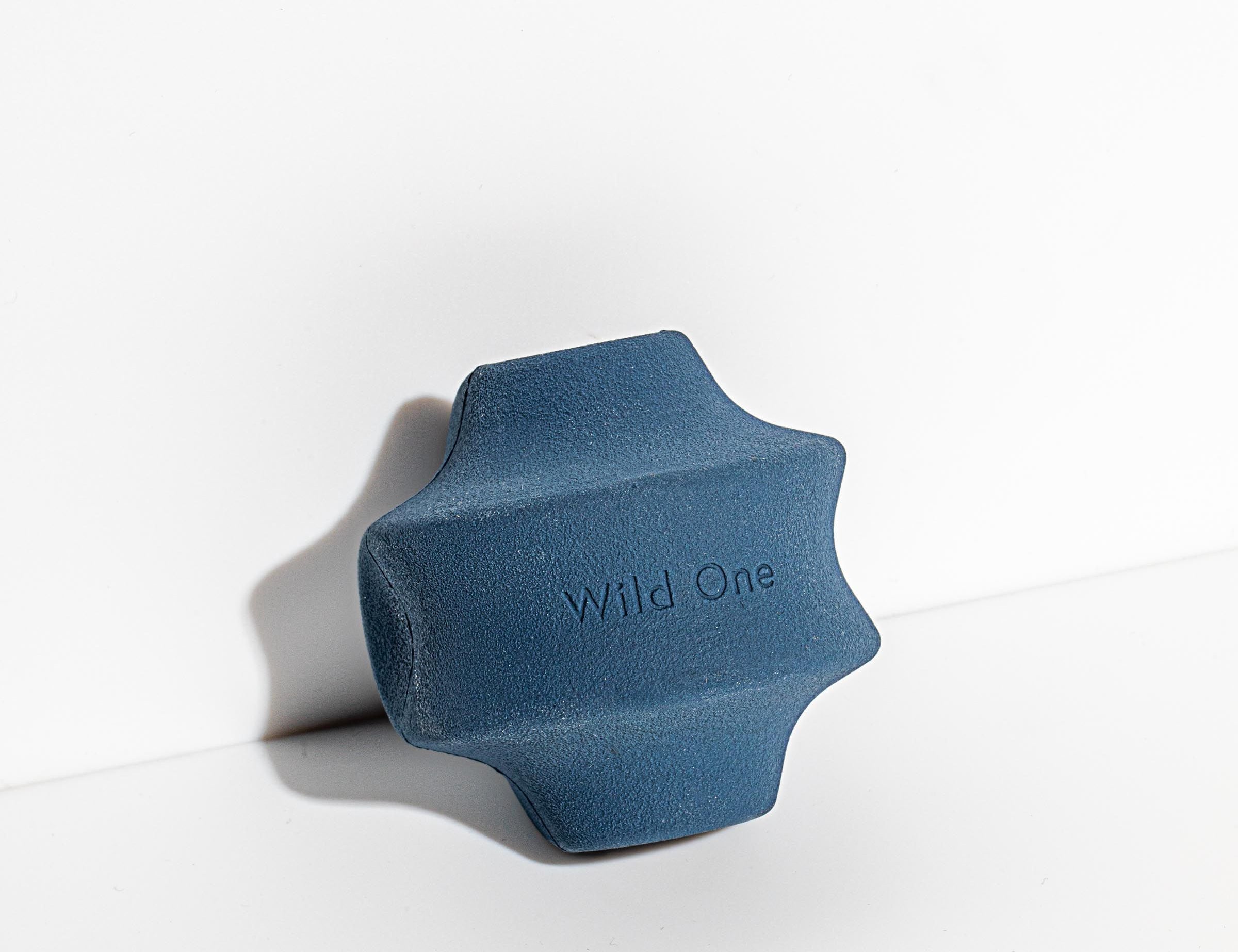 Wild One Twist Toss Dog Toy in Navy, a navy blue rubber twisted treat toy