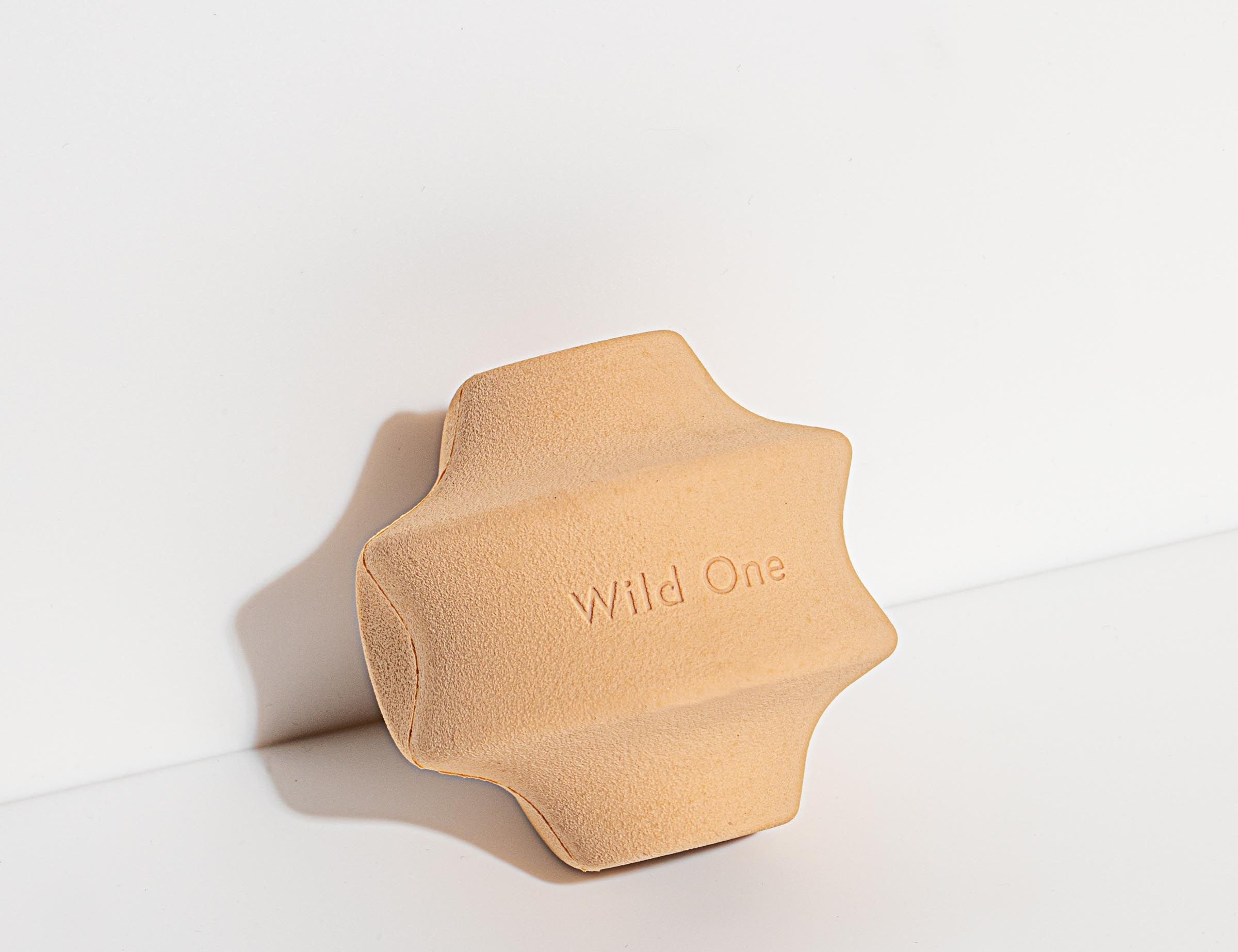 Wild One Twist Toss Dog Toy in Tan, a tan rubber twisted treat toy